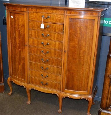 Lot 401 - A large walnut music cabinet with drawers to the centre, enclosing sheet music