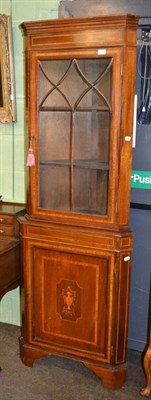 Lot 402 - An inlaid floor standing corner cupboard