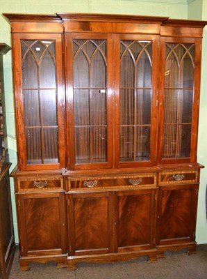 Lot 404 - A reproduction mahogany breakfront bookcase