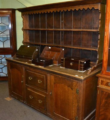 Lot 405 - An oak dresser base with two cupboard doors and two drawers, with an associated rack