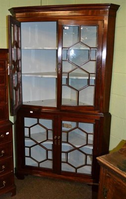 Lot 407 - A 19th century mahogany floor standing corner cabinet with glazed doors