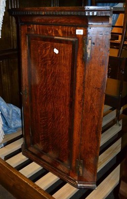 Lot 426 - A Georgian oak straight front hanging corner cupboard