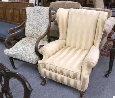 Lot 1156 - A 1920's Wing Chair, on ball and claw feet,...