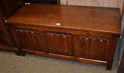 Lot 430 - A reproduction oak coffer/blanket box with carved linen fold panels