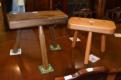 Lot 432 - A Yorkshire School modern bog oak three-legged stool and another ash stool (2)