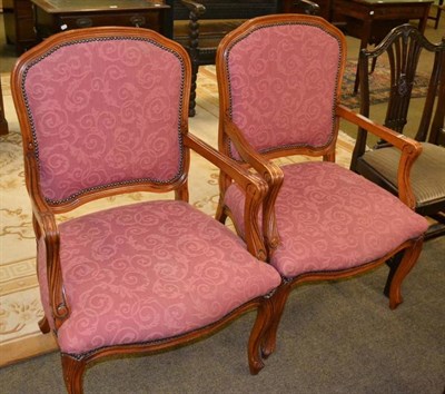 Lot 443 - A two tier dumb waiter and a pair of reproduction French style open armchairs