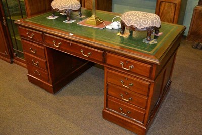 Lot 450 - A 20th century mahogany pedestal desk with green leather top