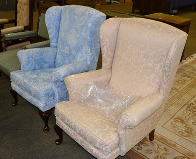 Lot 460 - Cream upholstered wing armchair on a mahogany frame and another similar upholstered in blue and...