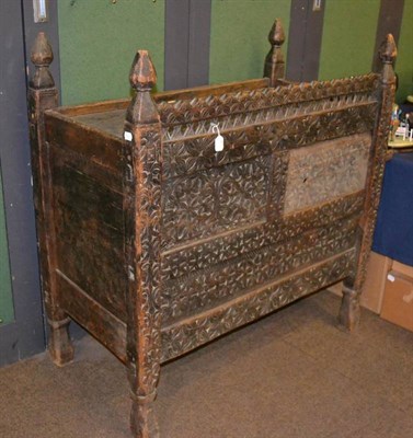 Lot 467 - An 18th century Continental cabinet of joined construction with carved panels and sliding door