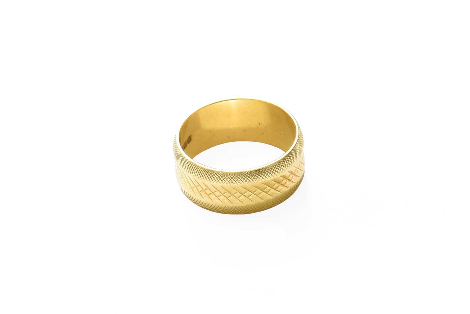 Lot 416 - An 18 Carat Gold Textured Band Ring, finger...