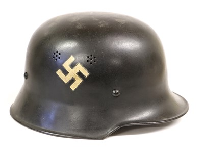 Lot 163 - A German M34 Police Helmet, with black paint...