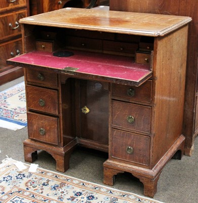 Lot 1249 - A George III Oak Kneehole Desk, the moulded...