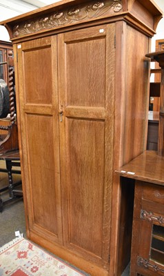 Lot 1330 - An Arts & Crafts Oak Wardobe, with embossed...