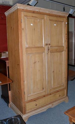 Lot 495 - A pine double wardrobe