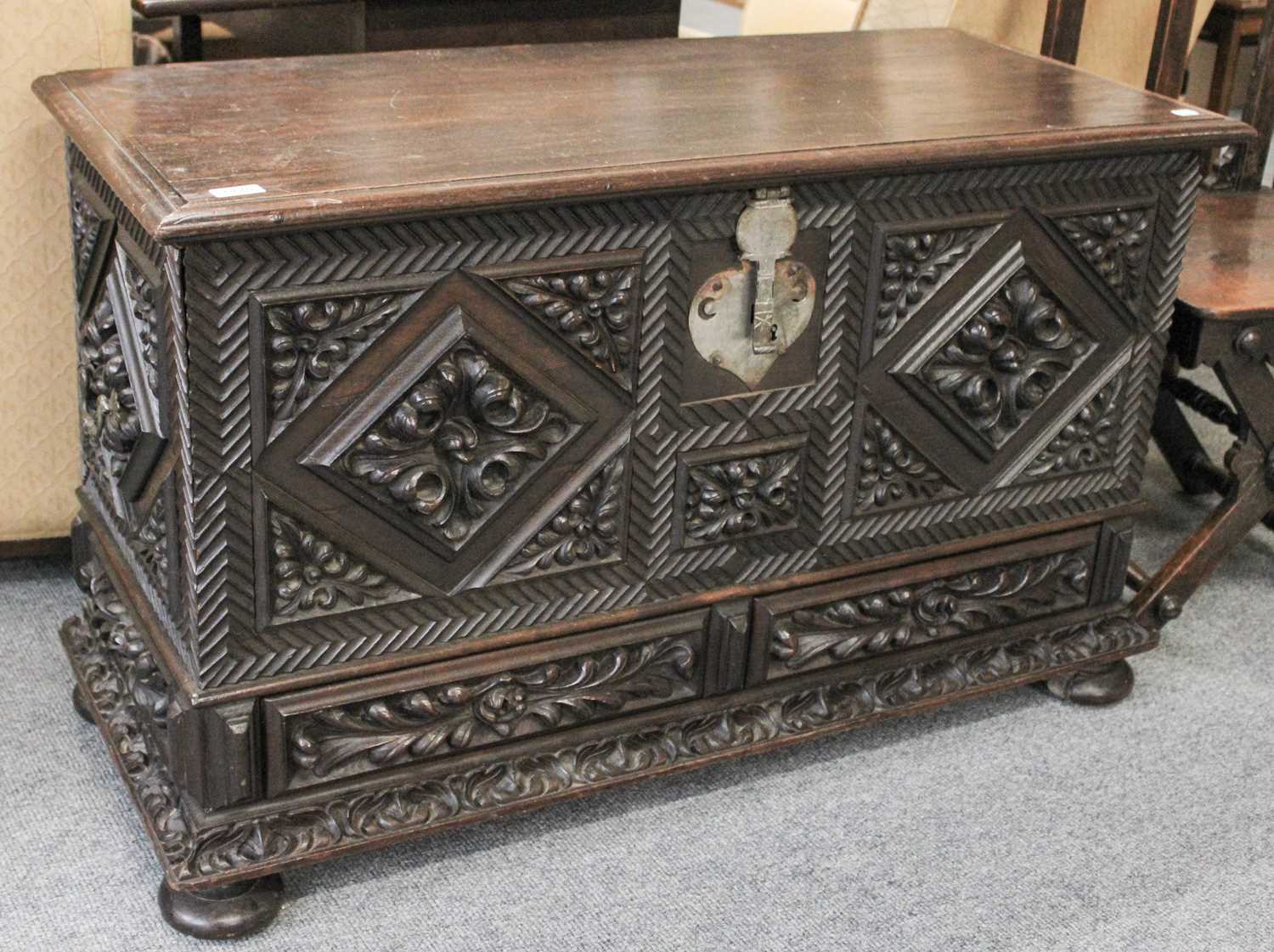 Lot 103 - An Intricately Carved Oak Kist, decorated with...