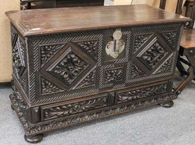 Lot 103 - An Intricately Carved Oak Kist, decorated with...