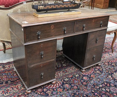 Lot 1394 - An Oak Kneehole Desk, 114cm by 50cm by 76cm...