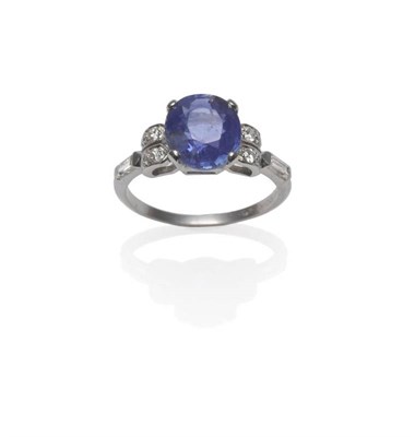 Lot 438 - An Art Deco Style Sapphire and Diamond Ring, the oval cut sapphire in a white four claw setting, to