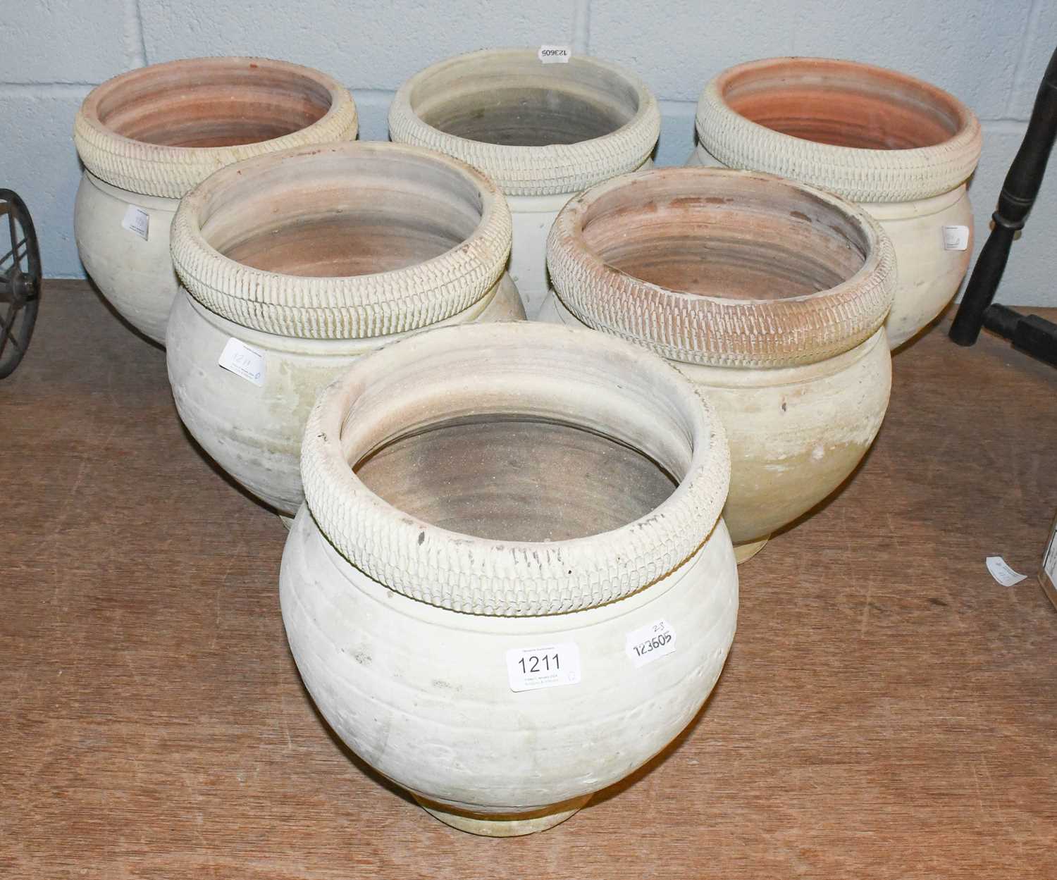 Lot 1211 - A Set of Six Painted Terracotta Planters, with...