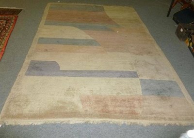 Lot 547 - A cream ground rug