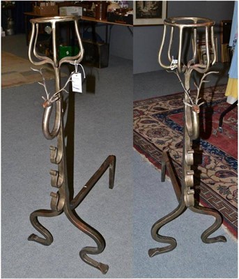 Lot 554 - A pair of large andirons, in Tudor style, with basket finials over stags' heads and scroll brackets