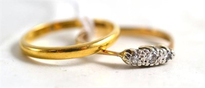 Lot 335A - A 22ct gold band ring and a diamond three stone ring (2)