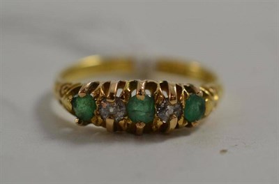 Lot 7 - Five stone diamond and emerald ring in 18ct gold