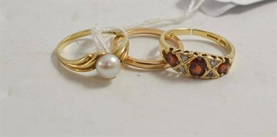 Lot 29 - A 9ct gold band ring, another with a cultured pearl and a garnet ring