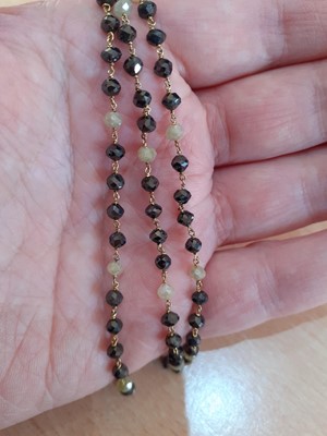 Lot 2044 - A Black and Yellow Diamond Bead Necklace four...