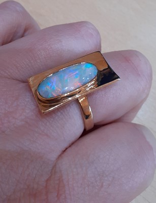 Lot 2083 - An Opal Ring the yellow plain polished...
