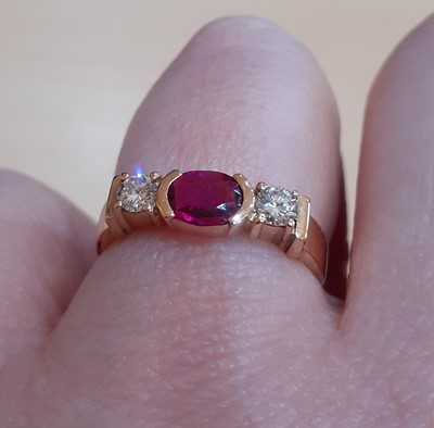 Lot 2043 - A Synthetic Ruby and Diamond Three Stone Ring...