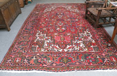 Lot 1005 - Heriz Carpet, the crimson field with central...