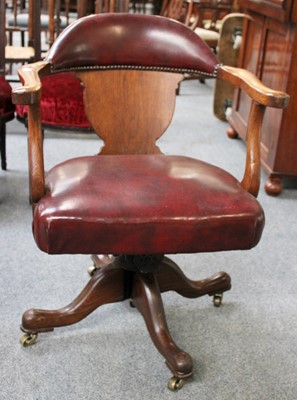 Lot 7 - A Red Leather Oak Framed Swivelling Office Chair