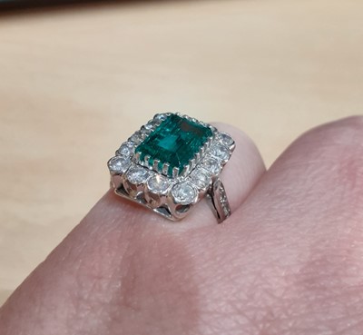 Lot 2333 - An Emerald and Diamond Cluster Ring the...