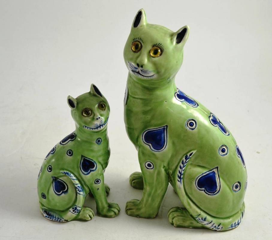 Lot 98 - A pair of pottery cats in the manner of Galle, probably Masonic, each decorated with blue...