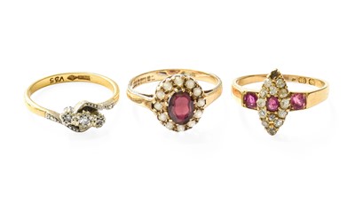 Lot 338 - An 18 Carat Gold Ruby and Diamond Cluster Ring,...