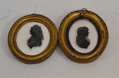 Lot 125 - Attributed to Isabella Beetham, two silhouettes reverse painted on glass of two ladies