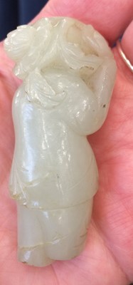 Lot 54 - A Chinese Jade Figure of a Boy, carrying a...