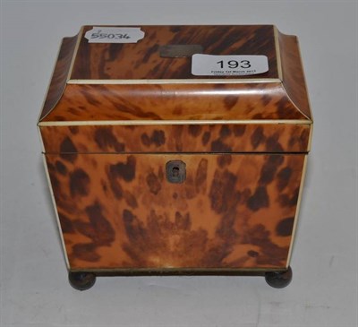 Lot 193 - An early 19th century tortoiseshell single division tea caddy raised on ball feet, 12cm high