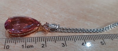 Lot 2271 - A Pink Tourmaline and Diamond Pendant on Chain...