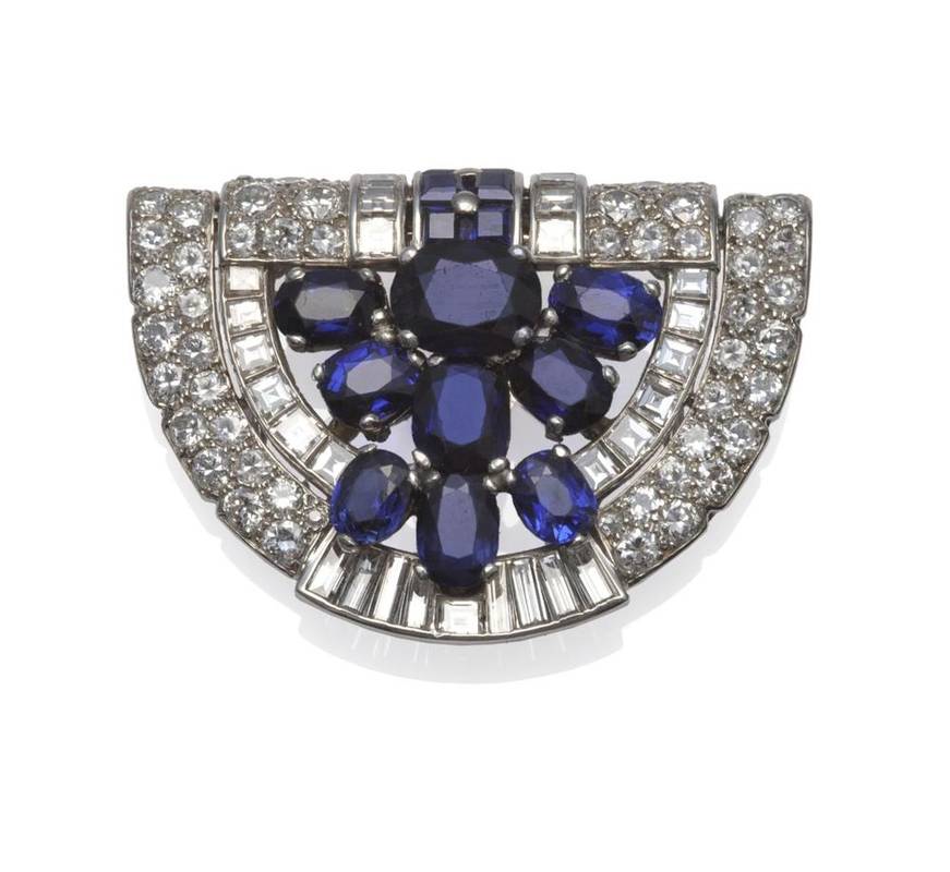 Lot 464 - An Art Deco Sapphire and Diamond Brooch, by Cartier, set throughout with oval cut and step cut...