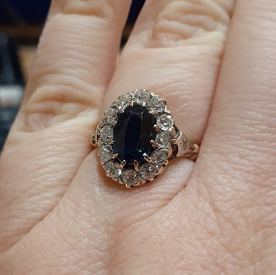 Lot 2139 - A Sapphire and Diamond Cluster Ring the oval...