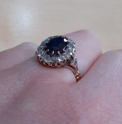 Lot 2139 - A Sapphire and Diamond Cluster Ring the oval...