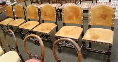 Lot 1366 - A Set of Six Leather Covered Oak Chairs,...