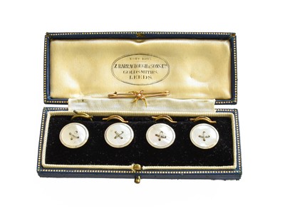 Lot 360 - Four Mother-of-Pearl Buttons, stamped '9CT',...