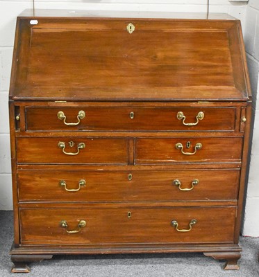 Lot 1282 - A George III Mahogany Bureau, cock-beaded and...