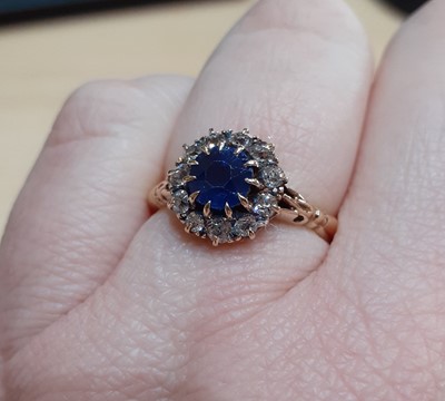 Lot 2140 - A Sapphire and Diamond Cluster Ring the round...