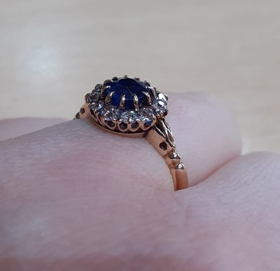 Lot 2140 - A Sapphire and Diamond Cluster Ring the round...