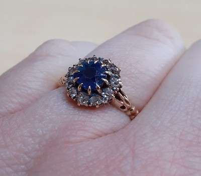 Lot 2140 - A Sapphire and Diamond Cluster Ring the round...