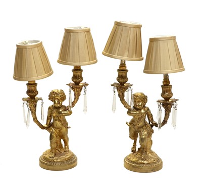Lot 152 - A Pair of French Gilt-Metal Figural Twin-Light...